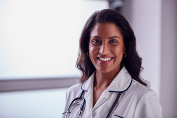 Portrait Of Female Mature Nurse In Uniform With Stethoscope In Hospital