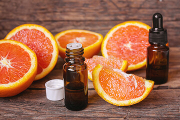 Grapefruit essential oil in a small bottle. Selective focus.