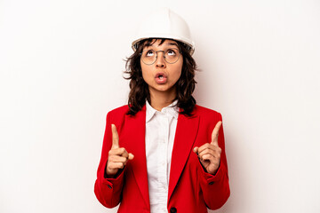 Young architect hispanic woman with helmet isolated on white background pointing upside with opened mouth.