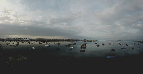 A lot of boats docked on a cloudy day