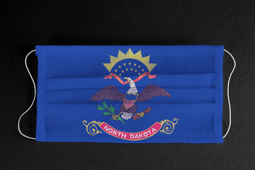 Coronavirus Covid-19 in North Dakota U.S. state. Flag of the State of North Dakota printed on...