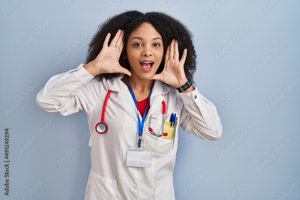 Poster young african american woman wearing doctor uniform and stethoscope smiling cheerful playing peek a 