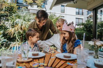Happy parents talking with children on birthday party at back yard