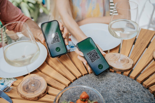 Couple showing green passes on their mobile phones