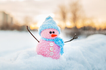 Cute homemade snowman with scarf and hat.