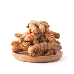 turmeric roots, traditional southeast asian spice on a wooden plate, also known for medicinal...