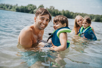 Family swimming in lake on weekend