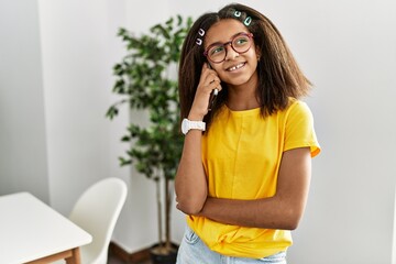 African american girl smiling confident talking on the smartphone at home