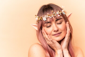 Young elf woman with pink hair isolated on beige background