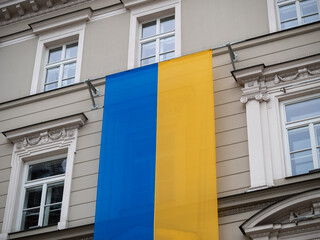 National flag of Ukraine. Blue and yellow state ensign hanging on the wall of a building at Main...