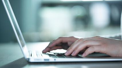 Woman hands on laptop keyboard
