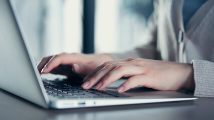 Woman hands on laptop keyboard