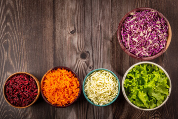Fresh grated vegetables in bowls on the table. Healthy food.