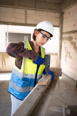 A cute-looking female engineer from Asia is using an electric screwdriver and wearing personal protective equipment.
Worker Wear a helmet, hard hat, gloves, safety glasses.Work safe concept.Prevention