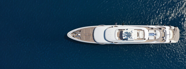 Aerial drone ultra wide panoramic photo of luxury yacht with wooden deck anchored in Mediterranean...