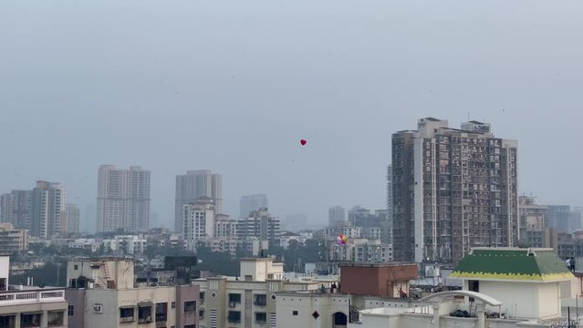 Colorful Balloons Flying Over Buildings In Mumbai City Near Bandra Worli Sea Link In India. elevated shot, wide