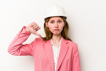 Young architect English woman with helmet isolated on white background showing a dislike gesture, thumbs down. Disagreement concept.