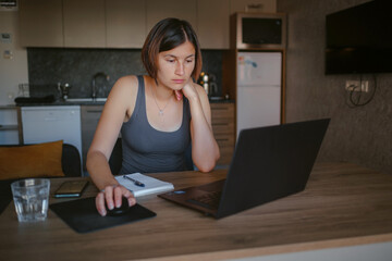 young asian woman at home, remote work at laptop. beautiful lady shopping or chatting online in social networks, having fun, watching movie, freelancer working on computer project.