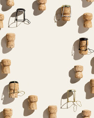 Frame with champagne corks on beige background with shadows at sunlight. Minimal style flat lay...