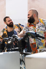 Young gay tourist couple outdoors. They are smiling and wearing summer clothes. 