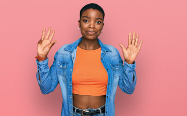 Young african american woman wearing casual clothes showing and pointing up with fingers number...