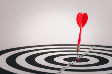 Bullseye is a target of business. Dart is an opportunity and Dartboard is the target and goal. Dart on center bullseye represent a challenge in success business marketing as concept.