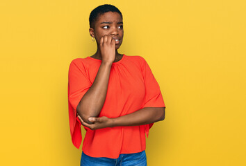 Young african american woman wearing casual clothes looking stressed and nervous with hands on mouth biting nails. anxiety problem.