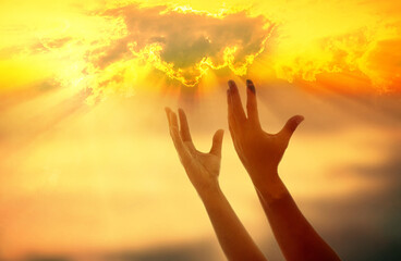 God's helping hand on sunset background.