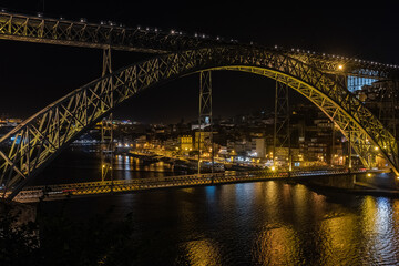 Fototapeta na wymiar Bridge Dom Louis Porto Portugal at night a double-deck metal arch bridge