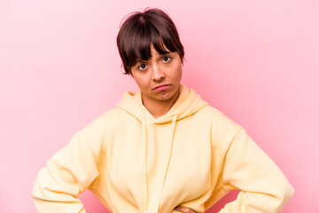 Obraz premium Young hispanic woman isolated on pink background sad, serious face, feeling miserable and displeased.