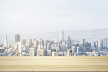 Empty wooden tabletop with beautiful San Francisco skyscrapers at daytime on background, mock up