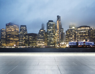 Empty concrete quay on the background of a beautiful blurry Manhattan skyline at twilight, mock up