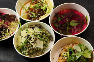 Balanced box diet. Menu suggestions in catering with delivery. Ready healthy food menu in lunch boxes with fish and vegetable packages as daily courier delivery diet plan on black background. 