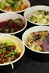Balanced box diet. Menu suggestions in catering with delivery. Ready healthy food menu in lunch boxes with fish and vegetable packages as daily courier delivery diet plan on black background.