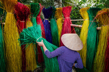 Vietnamese women drying traditional vietnam mats in the old traditional village at dinh yen, dong thap, vietnam, tradition artist concept,Vietnam.