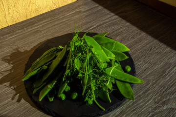 Top view of healthy organic food: green vegetables, seeds and herbs on light background. Source of protein for vegetarians.