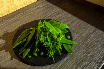 Top view of healthy organic food: green vegetables, seeds and herbs on light background. Source of protein for vegetarians.