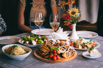 Plate with barbecue, sauce and salads. Dinner at the restaurant