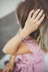 Fototapeta premium portrait of a beautiful woman a light violet sundress. vacation, enjoys life. delicate hand