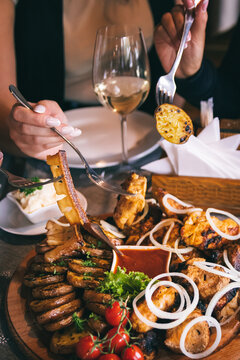 Plate with shashlyk and meat delicacies. Barbecue, baked potatoes with lard and onions.