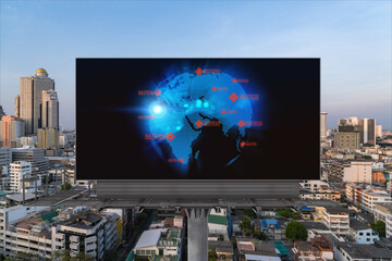 Glowing hologram of Earth planet map on billboard over aerial panoramic cityscape of Bangkok at sunset. The concept of international business in Southeast Asia.