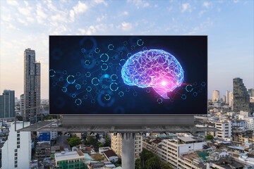 Brain hologram on billboard with Bangkok cityscape background at sunset. Street advertising poster. Front view. The largest science hub in Southeast Asia. Coding and high-tech science.