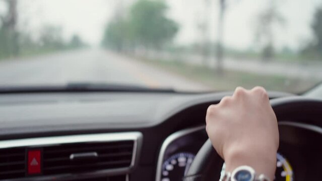 Woman focusing on the road while driving a car.