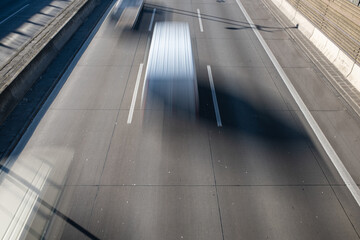 traffic on a German autobahn. View from a bridge to the highway with motion blurred vehicles. 