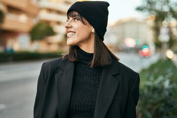 Young hispanic woman smiling happy standing at the city.