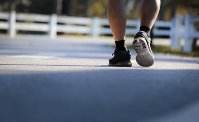 Naklejka premium Low angle view of senior man walking in park.Healthly concept.
