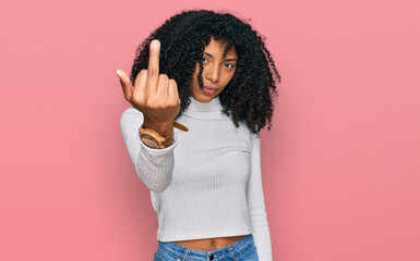 Young african american girl wearing casual clothes showing middle finger, impolite and rude fuck...