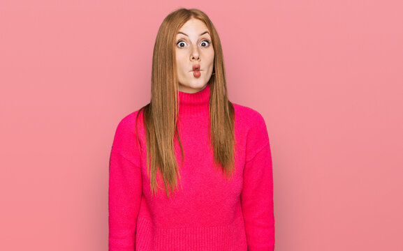 Young irish woman wearing casual clothes making fish face with lips, crazy and comical gesture. funny expression.