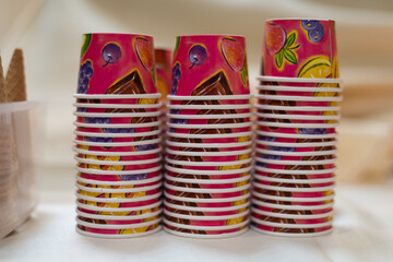 Fototapeta na wymiar Upside down stacks of colorful, small, disposable ice cream cups.