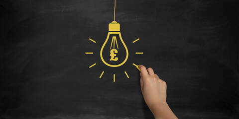 British Pound Symbol Bulb Drawing with Chalk on Blackboard by Female Hand